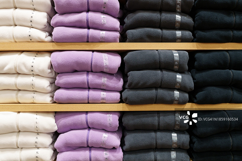 服装店货架上整齐排列的衣服图片素材