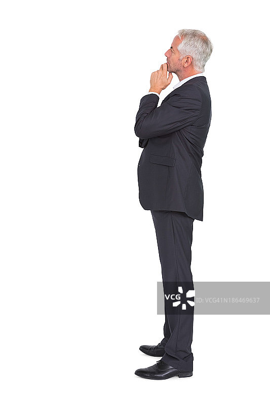 沉思的成熟商人摆姿势图片素材