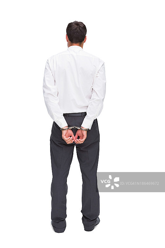 戴着手铐的年轻商人背影图片素材