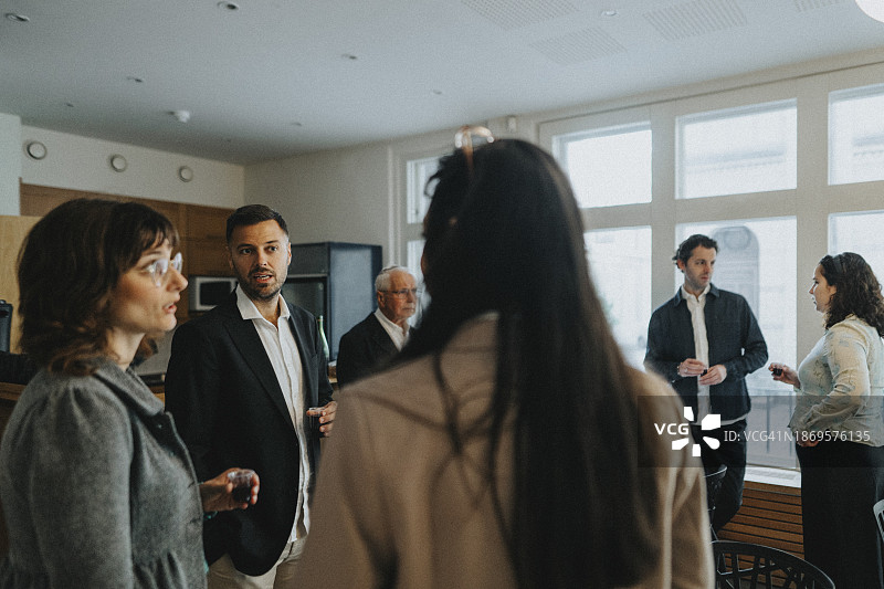 犹太教堂犹太人聚会期间，男女举杯饮酒交谈图片素材