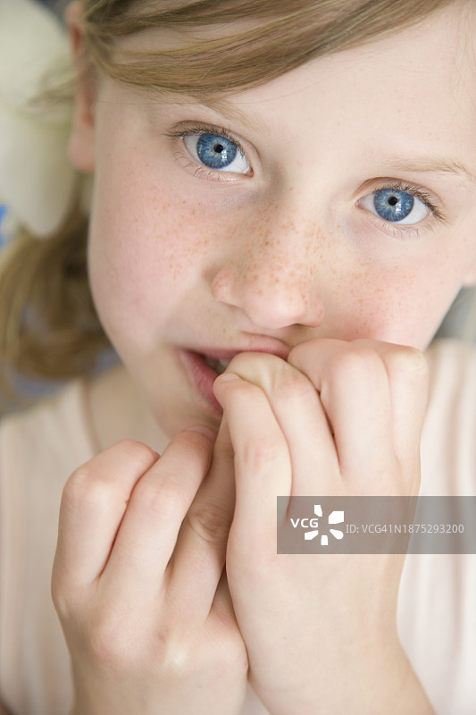 用手指放在嘴前的年轻女孩图片素材