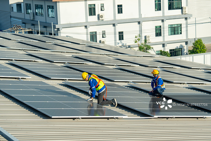 技术人员讨论检查和维护屋顶太阳能电池板图片素材