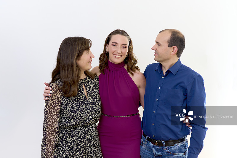 被父母拥抱，面向镜头的美丽女子图片素材