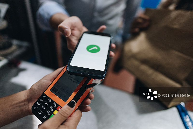 一个人用手机进行非接触式支付特写图片素材
