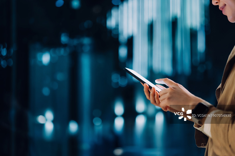 年轻亚裔女性使用手机进行创新移动交易图片素材