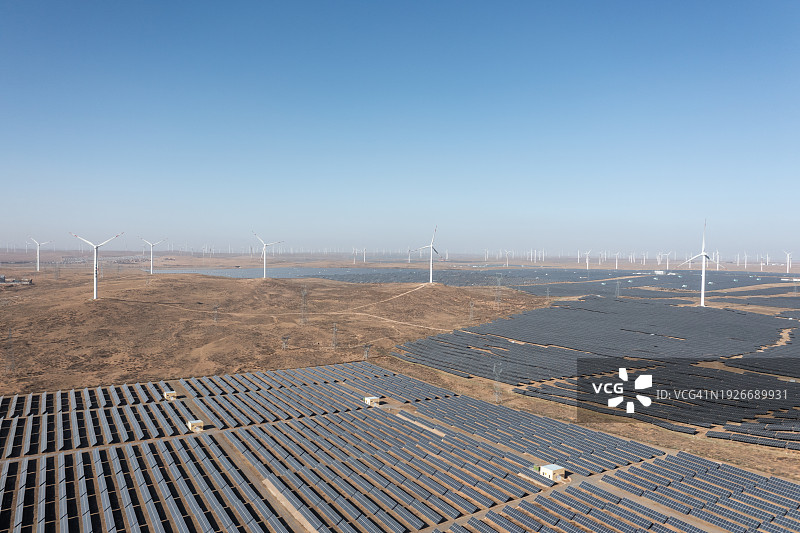 沙漠中的太阳能光伏板和风力涡轮机鸟瞰图图片素材