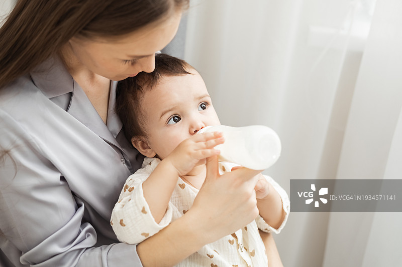 母亲用奶瓶喂宝宝图片素材