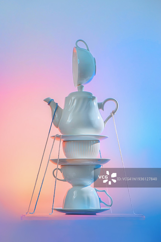 爱丽丝梦游仙境异想天开的茶歇时光，纸牌和不稳定的杯子，淡色背景图片素材