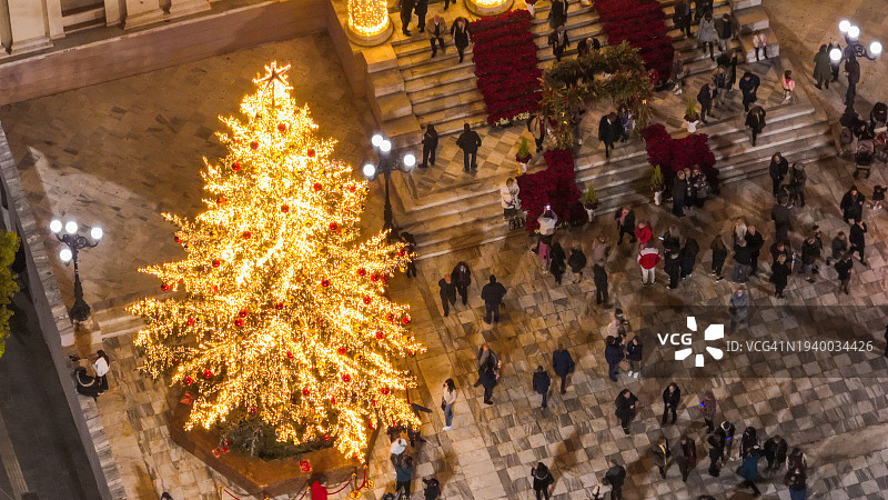 高角度拍摄的圣诞树旁的人们图片素材