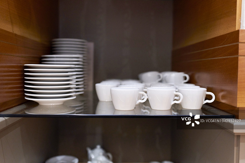 厨房架子上的一小组干净整洁的白色瓷器餐具照片图片素材