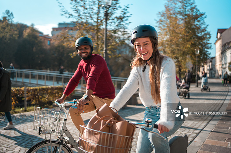 在城市里骑自行车的多元化朋友图片素材