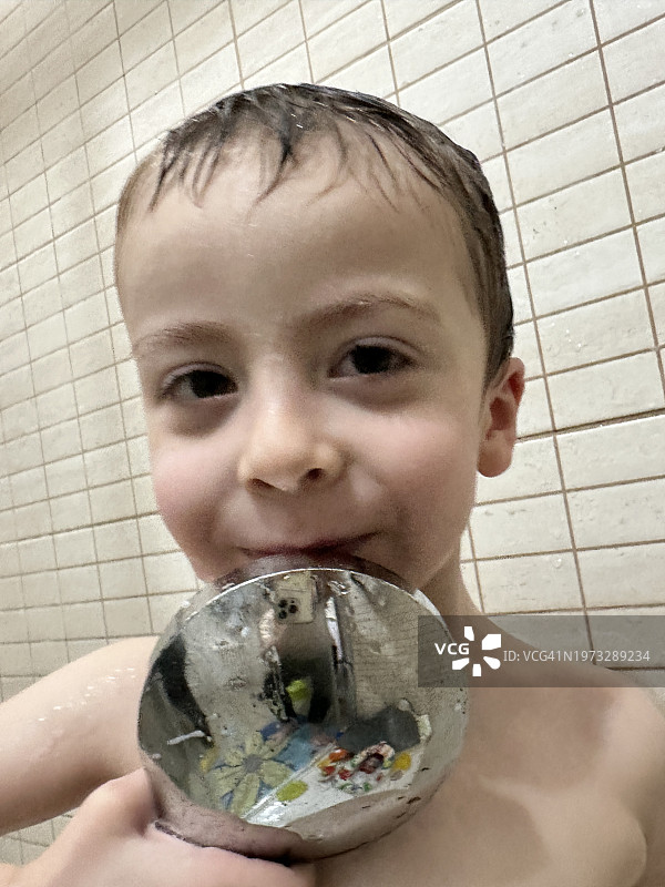 淋浴后在浴室洗脸擦干的三岁男孩图片素材