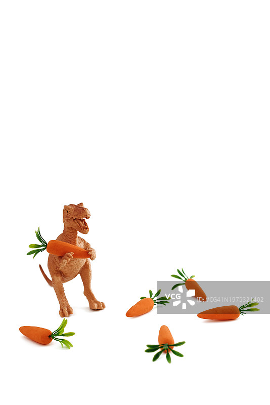 恐龙玩具拿着胡萝卜，白色背景图片素材