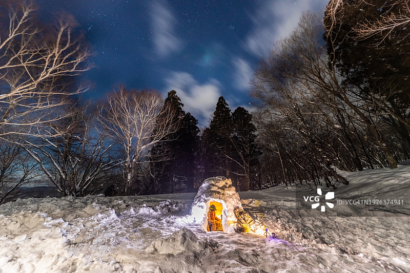 女人在冬季森林的冰屋里独自露营图片素材