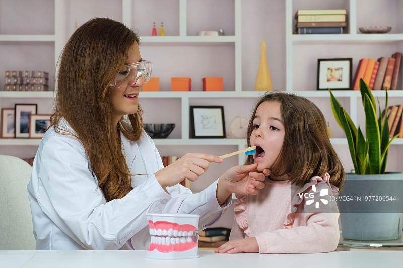 牙医教女孩如何刷牙图片素材