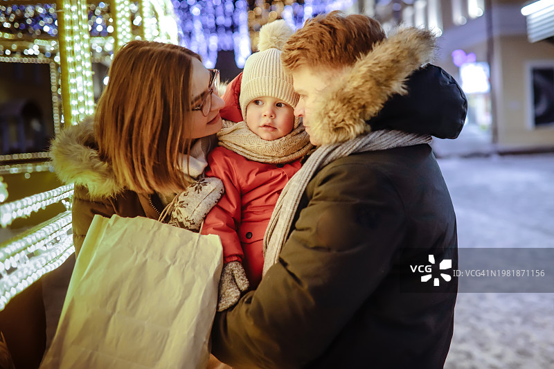 冬季灯光下的年轻家庭街头人像图片素材