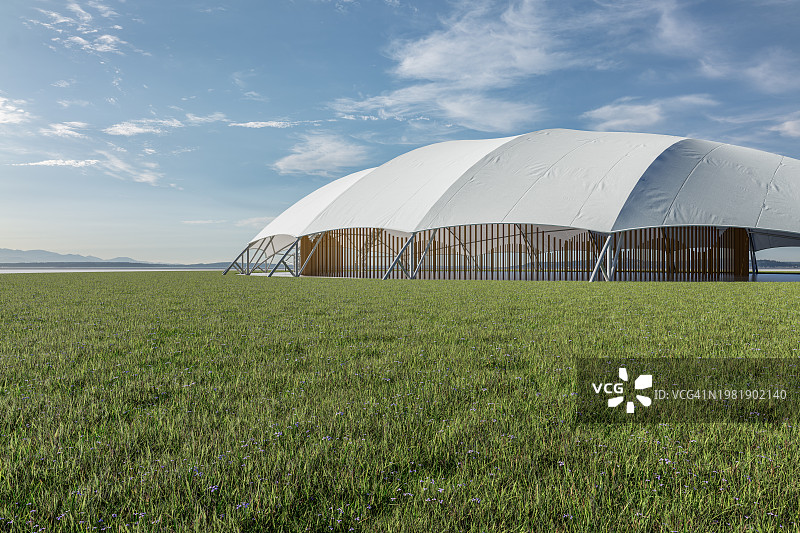 天空下郁郁葱葱的草坪上的活动帐篷图片素材