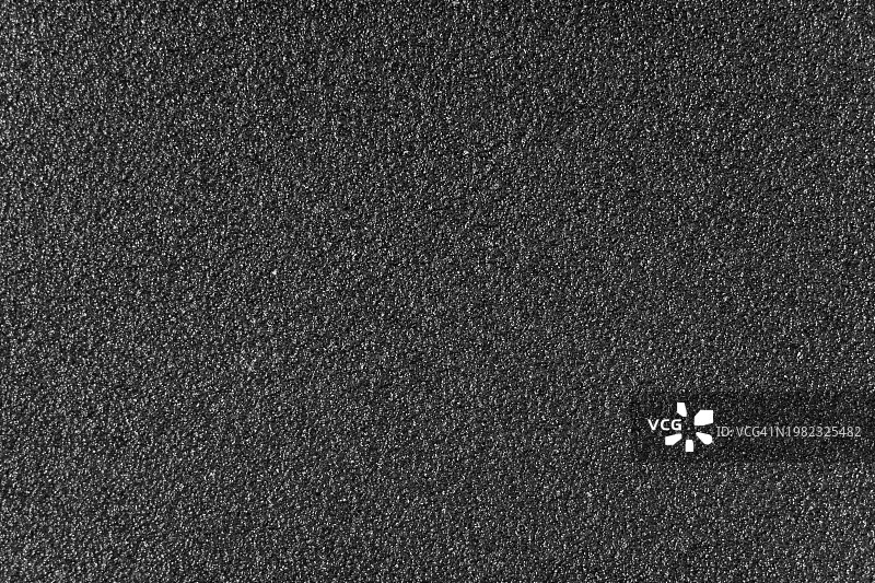 黑色粗砂纸的纹理特写图片素材