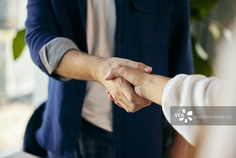 年轻商人在办公室与女商人握手图片素材