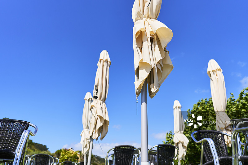 户外活动中的雨伞和空桌椅图片素材