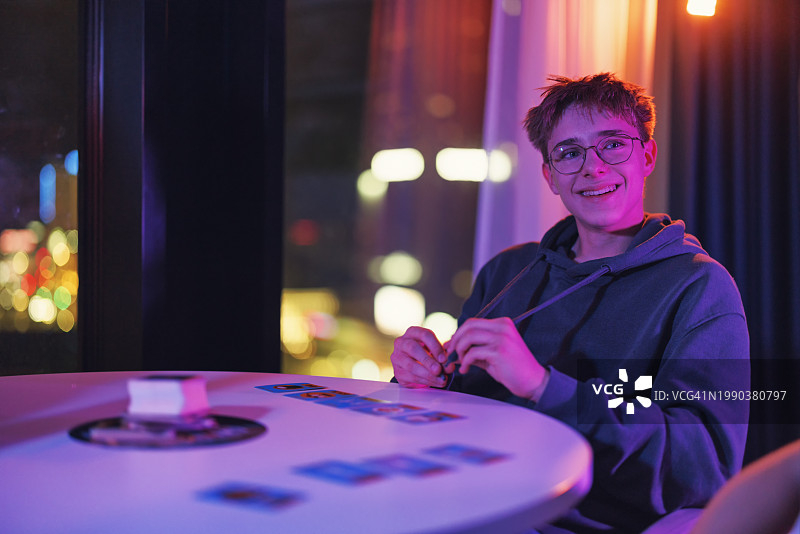 青少年男孩夜晚玩纸牌游戏图片素材