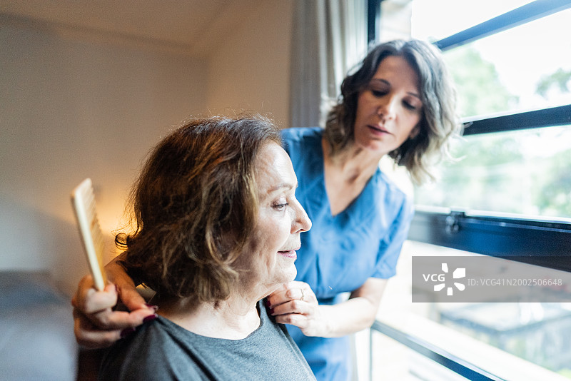 居家护理员在家为老年妇女梳头图片素材
