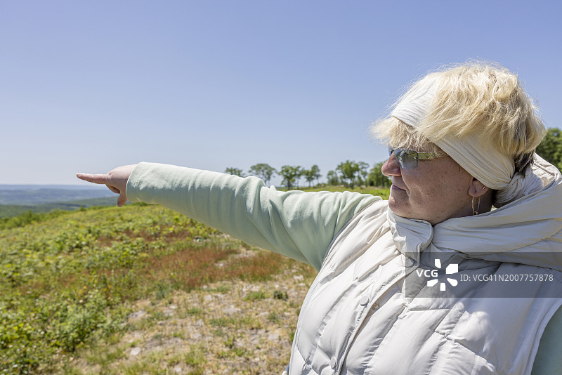 中年妇女在宾夕法尼亚州波科诺山区旅行时展示山景图片素材