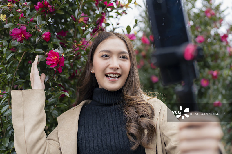 中国台湾济州岛冬季玫瑰花园里的旅行博主直播图片素材