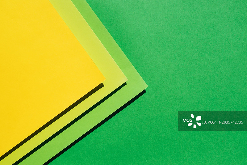 通用彩色背景。文本和图片背景。纸质基底。复制空间。明亮的黄绿色背景。图片素材