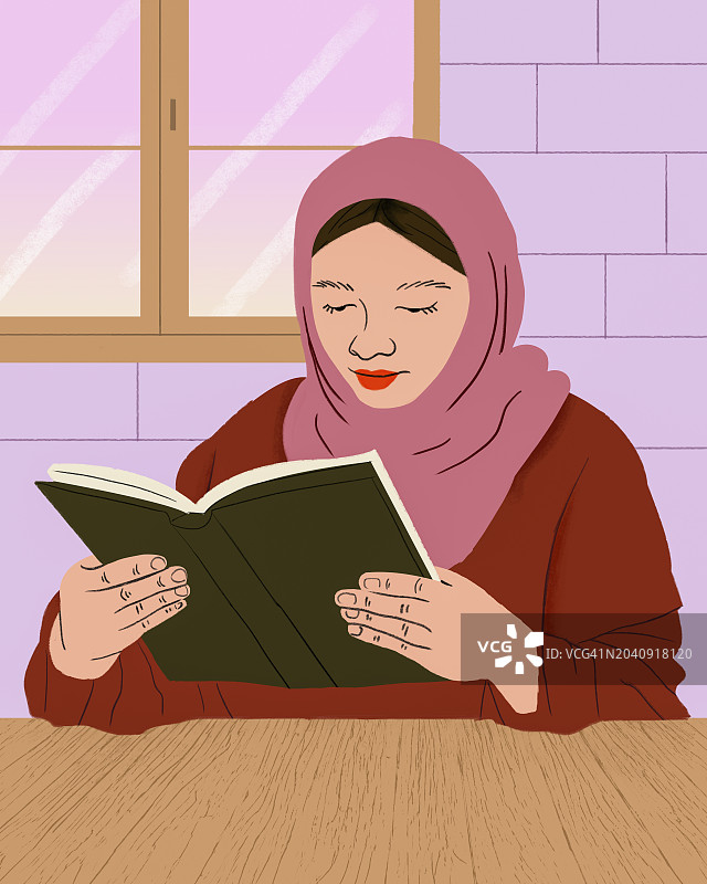 戴头巾的穆斯林妇女在桌旁看书图片素材