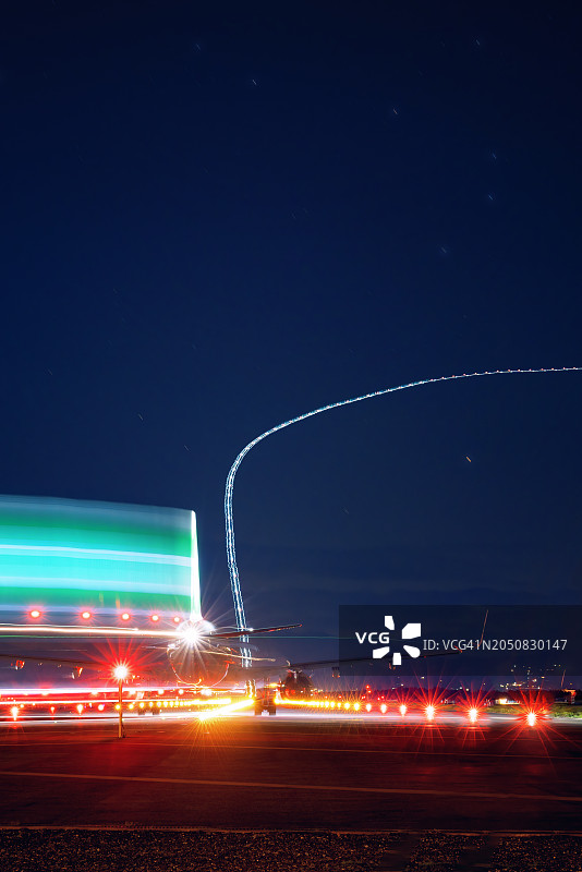 跑道上飞机起飞长曝光光迹图片素材