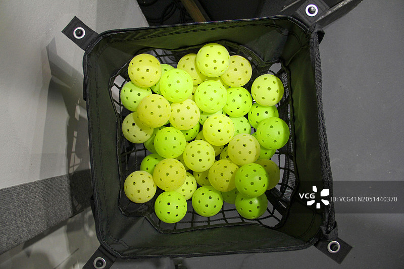 室内装满匹克球的球车图片素材