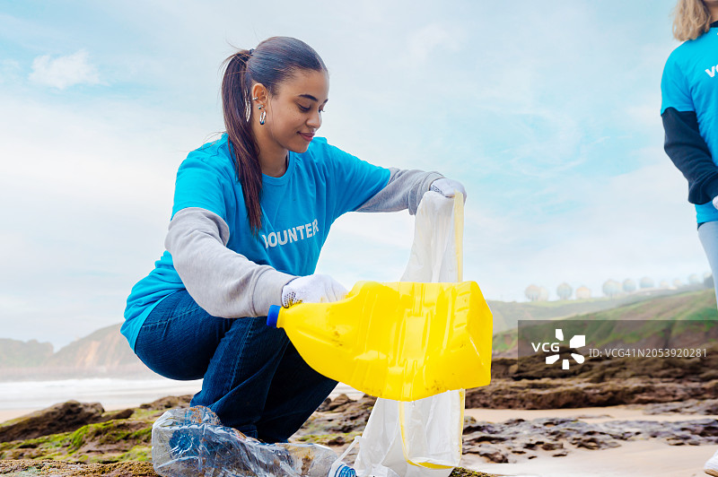 在海滩清理垃圾的志愿者图片素材