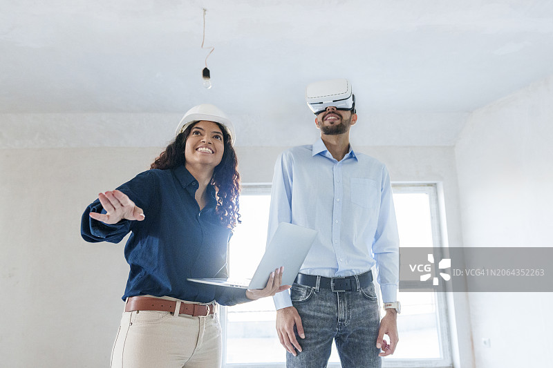 在房产经纪人展示新房附近使用虚拟现实模拟器的男人图片素材