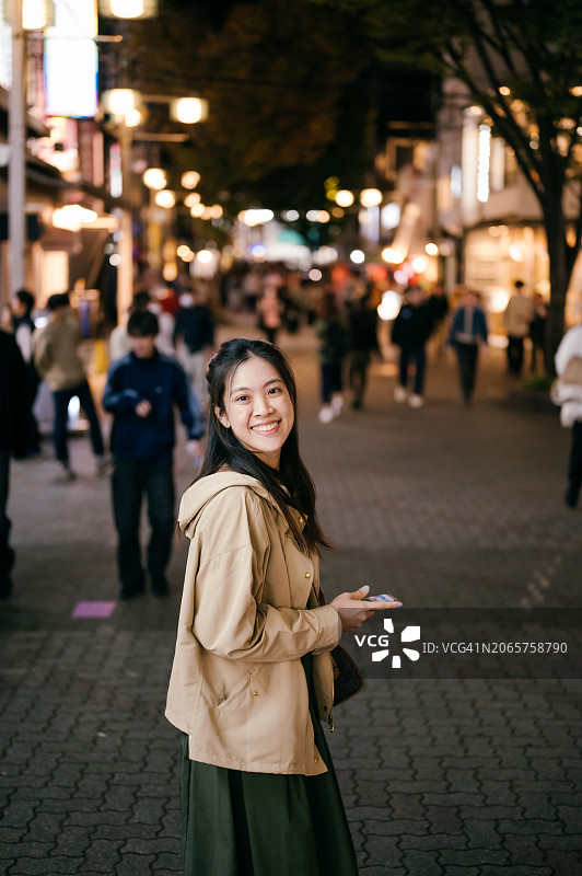 亚洲千禧一代在豪华餐厅微笑聊天，通过客户服务进行预订的奢华生活方式图片素材