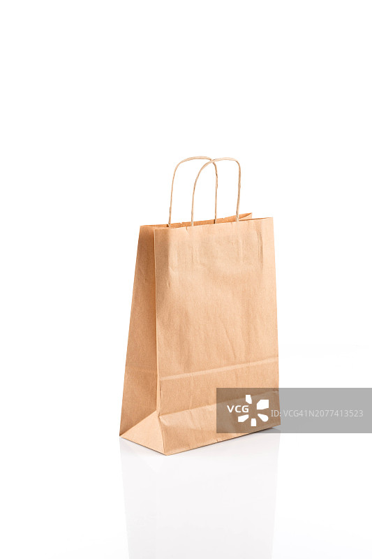 再生纸牛皮购物袋：白色背景上的包装袋图片素材