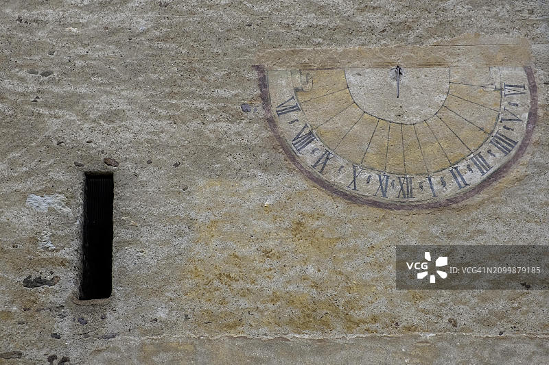 意大利卡尔特恩，风化房屋立面上的日晷图片素材