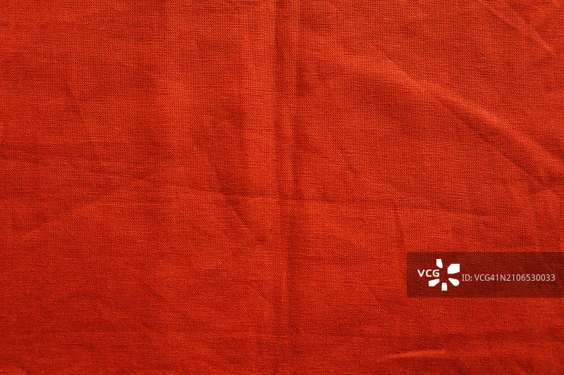 红色天然亚麻纺织背景。顶部视图。平铺，复制空间。图片素材