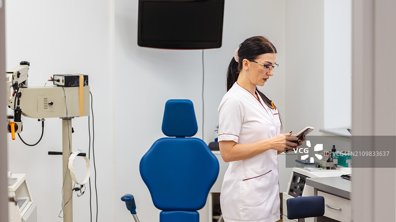 护士使用手机App调整耳鼻喉科医疗器械图片素材