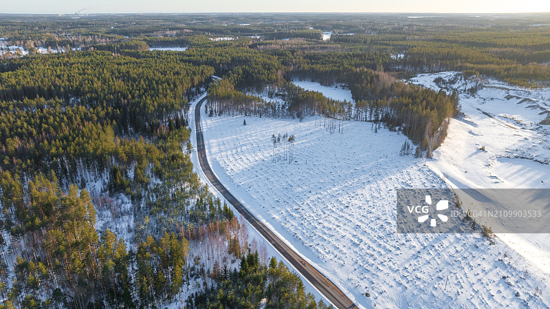 航拍冬季穿过森林的柏油路图片素材