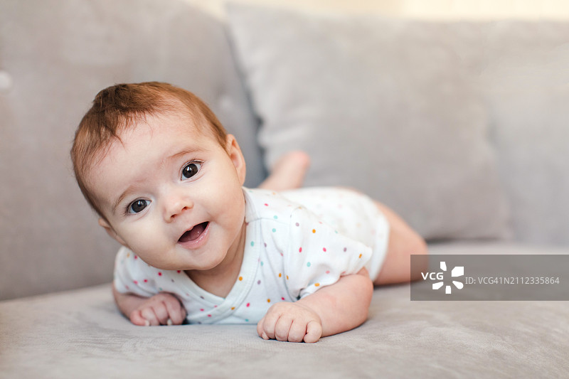 家里躺在沙发上的可爱女婴肖像图片素材