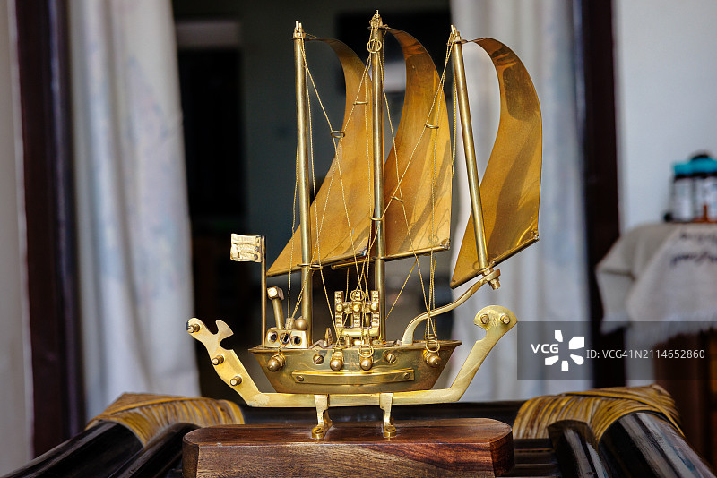 放置在客厅桌子上的装饰金属船图片素材