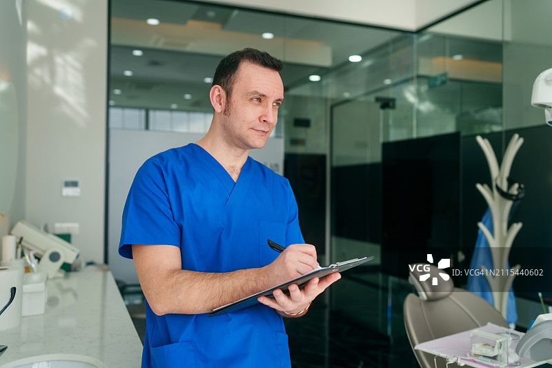 医护人员在诊所的剪贴板上书写图片素材