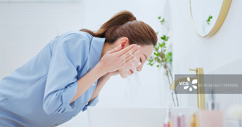开心地洗脸的亚洲女人图片素材