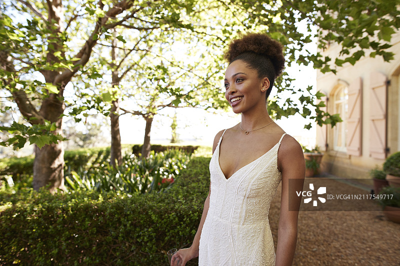 微笑的年轻美丽新娘身穿白色婚纱图片素材