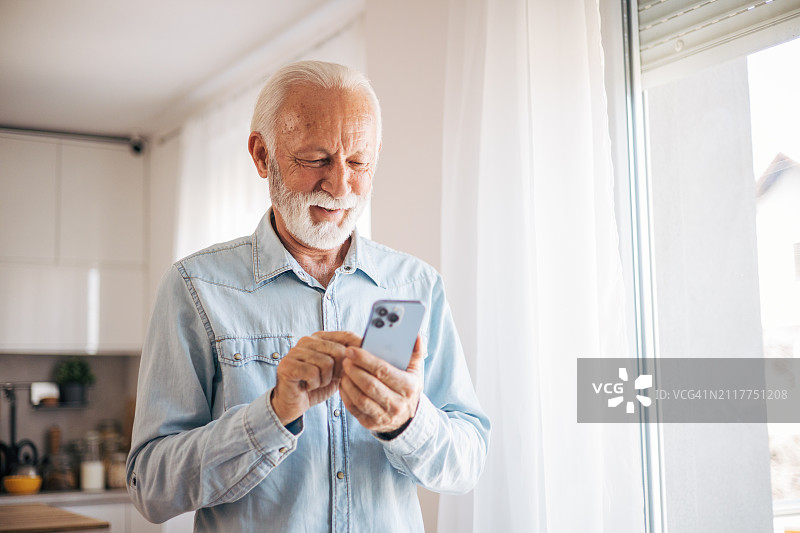 年长的男人发短信和使用移动设备图片素材