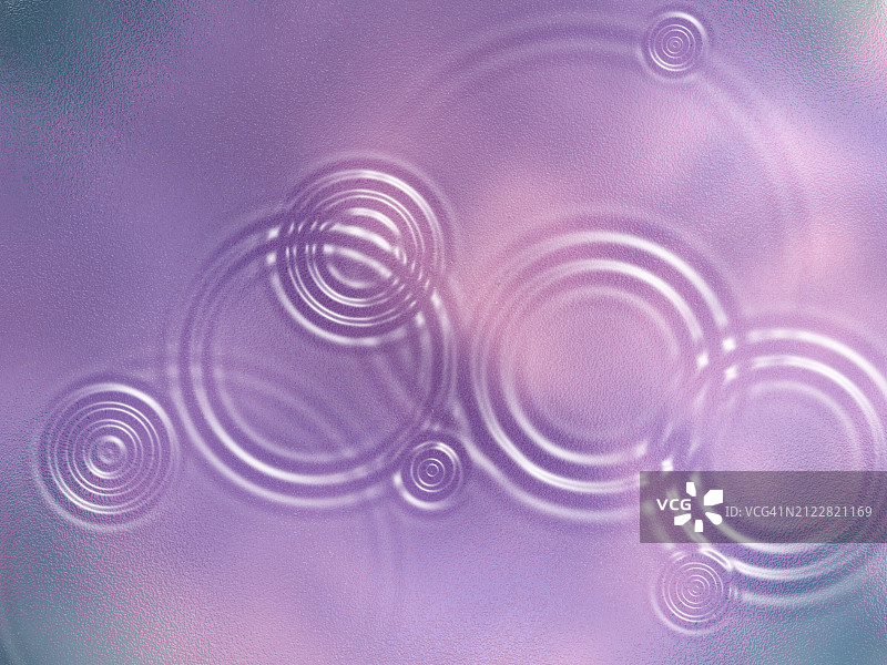 水滴落在粉色透明表面产生的涟漪图片素材