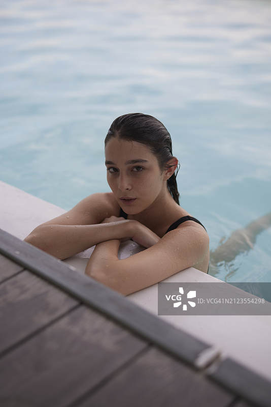 年轻女人在泳池边放松图片素材