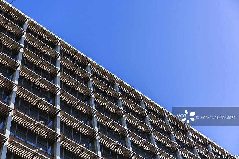 蓝色天空下的玻璃幕墙现代办公大楼图片素材