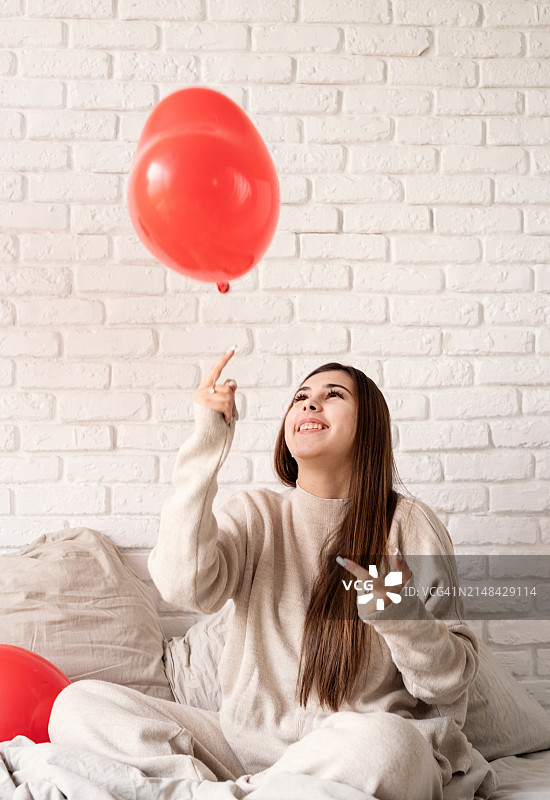 女人在家中床上玩气球图片素材